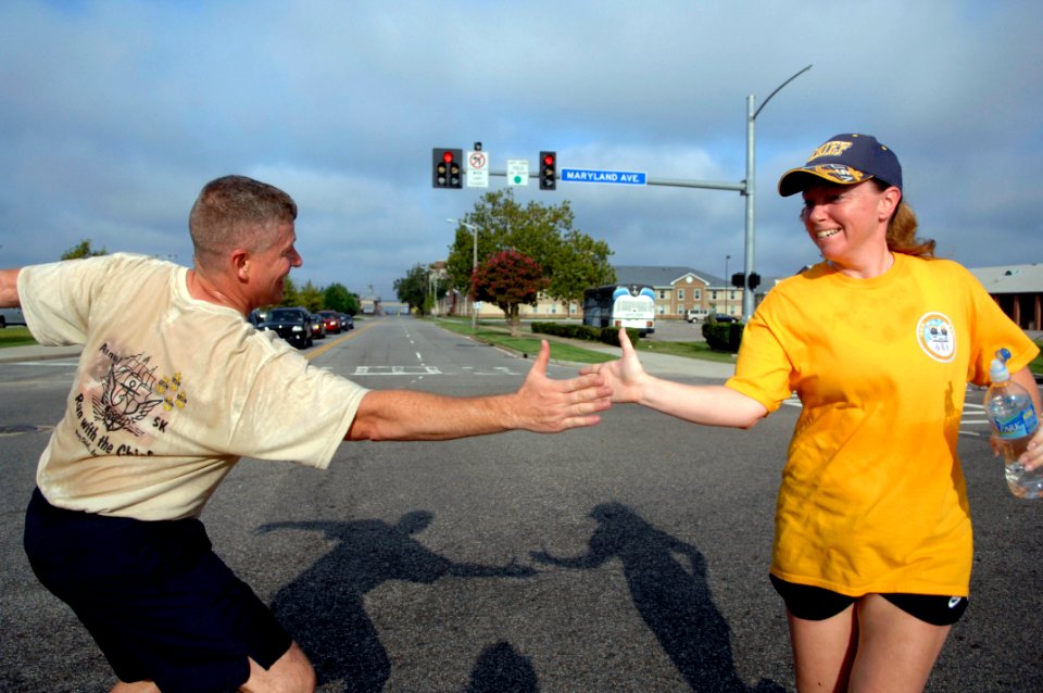 US Navy 090822-N-9818V-318 Master Chief Petty Officer of the Navy (MCPON) Rick West cheers on racers participating in the fifth annual Run with the Chiefs 5 kilometer run at Naval Station Norfolk