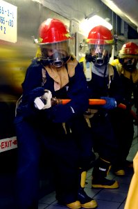 US Navy 090824-N-6003P-107 Sailors aboard the aircraft carrier USS Harry S. Truman (CVN 75) prepare to battle a compartment fire during a general quarters drill. Harry S. Truman is underway conducting carrier qualifications