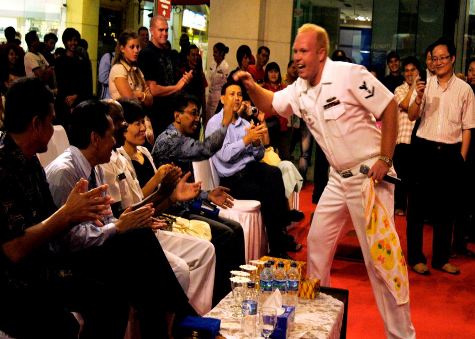 US Navy 090826-N-5060D-277 Musician 3rd Class Drew Williams high-fives audience members at Artha Gading Mall during a joint performance by the brass section of the Indonesian TNI Navy Band and the U.S. 7th Fleet Rock Band, Orie