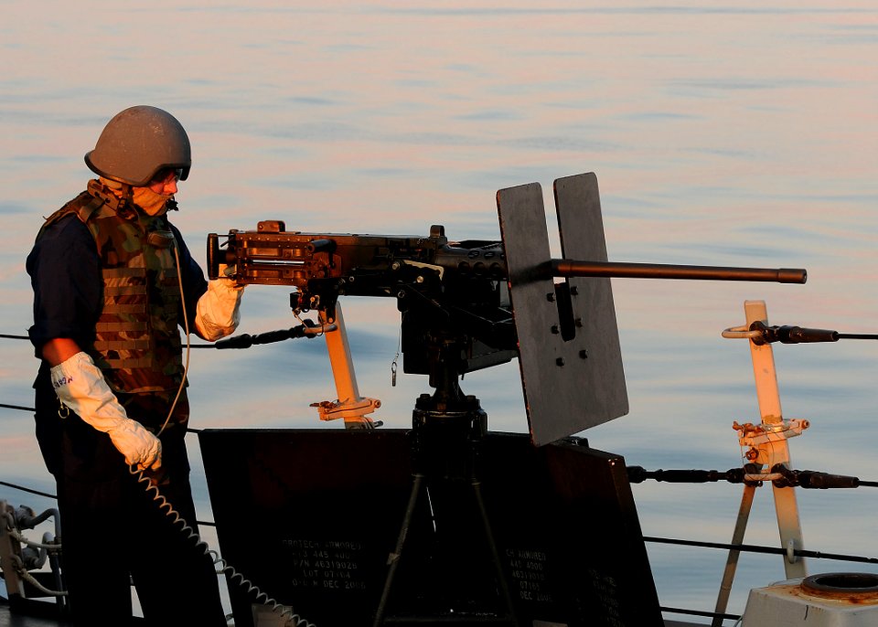 US Navy 090824-N-1522S-017 Gunner's Mate 1st Class Matthew Davis prepares to man a .50-caliber machine gun aboard the guided-missile destroyer USS Farragut (DDG 99)