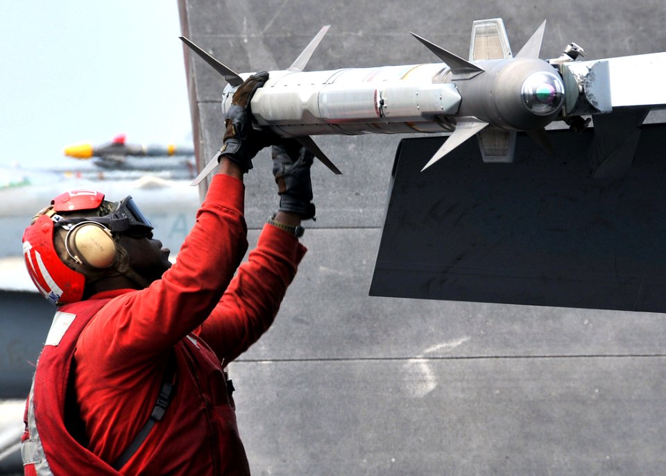 US Navy 090824-N-6233H-023 Aviation Ordnanceman 3rd Class Clarence Young inspects an AIM-9X Sidewinder missile before the launch of an F-A-18F Super Hornet from the Diamondbacks of Strike Fighter Squadron (VFA) 102