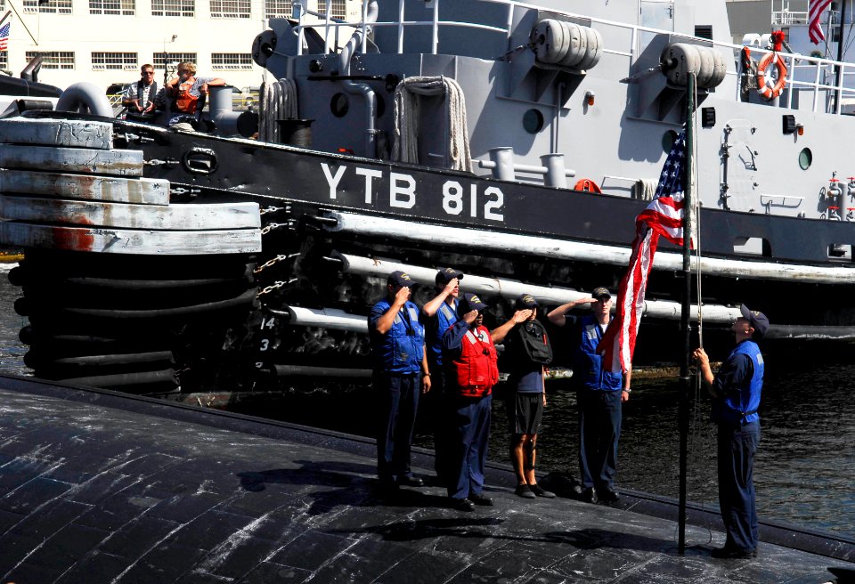US Navy 090826-N-9928E-085 Sailors aboard the Los Angeles-class attack submarine USS Bremerton (SSN 698) raise the national ensign after pulling into port at Naval Base Kitsap, Wash., for a scheduled port visit
