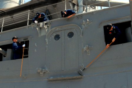 US Navy 090825-N-2600H-231 Sailors assigned to the aircraft carrier USS Nimitz (CVN 68) paint a cargo door during a community service project to restore the historic Japanese battleship Mikasa