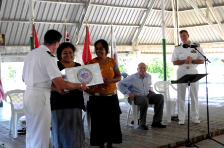 US Navy 090824-N-9689V-005 Mission chaplain Lt. Todd Delaney, presents representatives from the Red Cross and the Kiribati Association of Non-Governmental Organizations, with donations on behalf of Project Handclasp