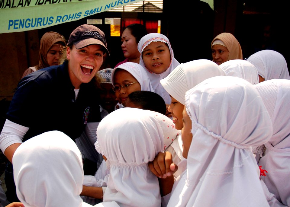 US Navy 090825-N-8539M-060 Ensign Ashley Rushing, assigned to the guided-missile destroyer USS Russell (DDG 59), greets a group of Indonesian girls at Nural Falah Elemetary School