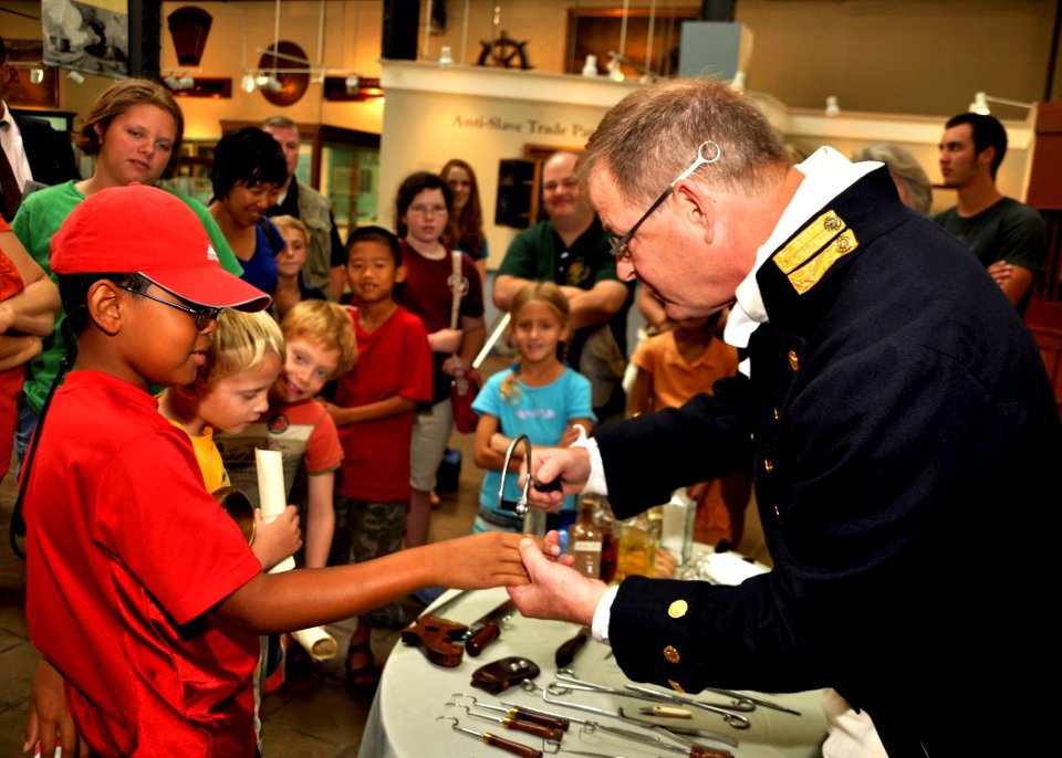 US Navy 090826-N-9671T-061 Charlie Quesenberry, a history re-enactor playing the role of the ship's surgeon, demonstrates the use of a bone saw on a volunteer during a