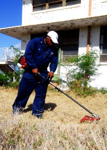 US Navy 090829-N-0995C-025 Chief Culinary Specialist (Sel.) Frankie Lee landscapes an area outside an abandoned air control tower on Ford Island