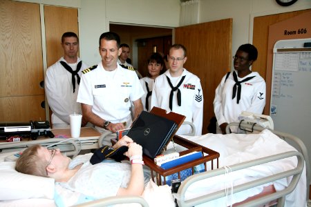US Navy 090824-N-3271W-110 Sailors assigned to U.S. Strategic Command and Navy Operational Support Center visit with a patient at Children's Hospital Of Omaha