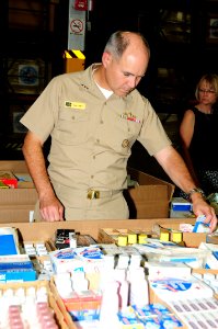US Navy 090827-N-3570S-035 Vice Adm. Richard Hunt, commander, U.S. 3rd Fleet looks over a Project Handclasp pallet of donated clothes, toys, food and medical supplies