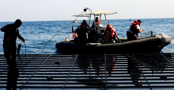 US Navy 090829-N-5214S-078 Sailors aboard a rigid hull inflatable boat return to the well deck of the multi-purpose amphibious assault ship USS Bataan (LHD 5) photo