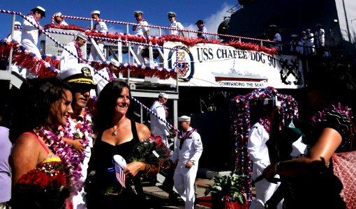 US Navy 090824-N-7498L-083 Cmdr. Larry Gonzales, executive officer of the guided-missile destroyer USS Chafee (DDG 90), poses with his family by the brow of the ship upon return to Naval Station Pearl Harbor after a seven-month