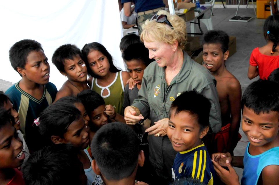 US Navy 090826-N-9689V-016 Donna Willard, wife of U.S. Pacific Fleet commander Adm. Robert F. Willard, speaks with children at Betio Sports Complex during a Pacific Partnership 2009 medical civic action project