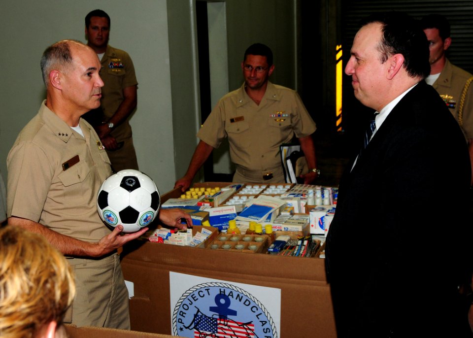 US Navy 090827-N-3570S-048 Vice Adm. Richard Hunt, Commander, U.S. 3rd Fleet listens to Paul Brown, director of Project Handclasp, explain how U.S. 3rd Fleet can help Project Handclasp deliver their projects overseas more effec