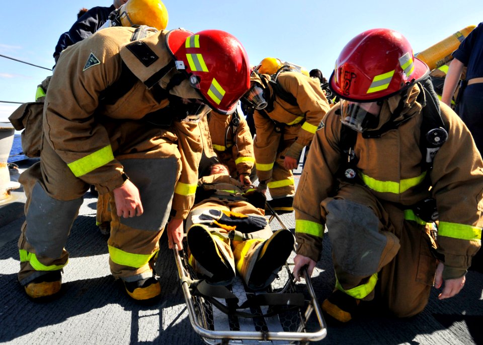 US Navy 090830-N-2638R-003 Junior officers prepare to lift a teammate in a stretcher during a damage control Olympics