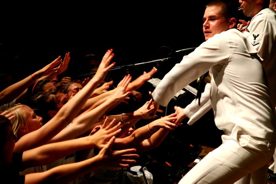 US Navy 090828-N-3271W-077 Musician Seaman Apprentice Steven Lamonica shakes hands with students during a performance of the U.S. Navy Band Great Lakes