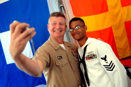 US Navy 090827-N-9818V-405 Master Chief Petty Officer of the Navy (MCPON) Rick West takes pictures with chief petty officer selects during a heritage training formal dinner aboard the USS Constitution