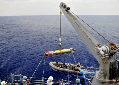 US Navy 090828-N-2638R-002 A MK-46 recoverable exercise torpedo (REXTORP) is hoisted aboard the guided-missile destroyer USS Mustin (DDG 89) during a REXTORP exercise