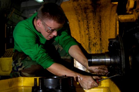 US Navy 090831-N-3038W-037 viation Support Equipment Technician Airman Apprentice Justin Mowery performs maintenance on the brake assembly of a 6K forklift aboard the aircraft carrier USS Nimitz (CVN 68)