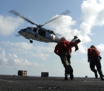 US Navy 090827-N-7364R-049 Sailors aboard the aircraft carrier USS Harry S. Truman (CVN 75) prepare to receive supplies from the dry cargo-ammunition ship USNS Supply (T-AOE 6)
