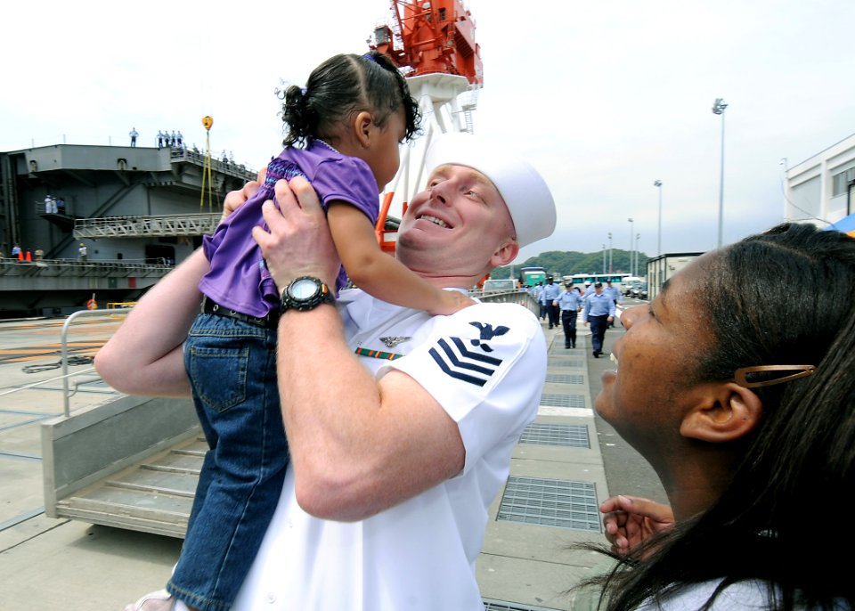 US Navy 090903-N-1062H-077 Chief Aviation Ordnanceman (Sel.) Charles Green raises his daughter into his arms during the return of the aircraft carrier USS George Washington (CVN 73) to Yokosuka, Japan
