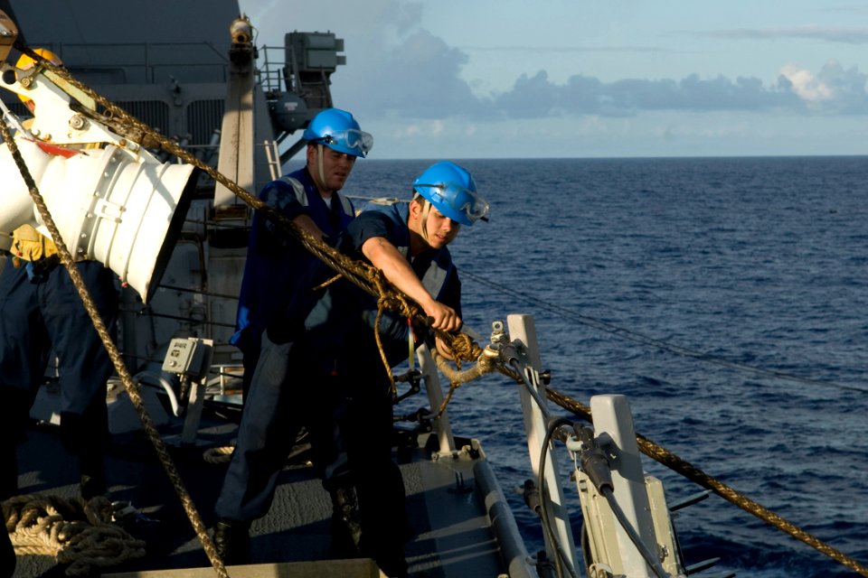 US Navy 090829-N-9123L-015 Boatswain's Mate 3rd Class Ray Brown, from Kalamazoo, Mich., cuts line from a span wire aboard the guided-missile destroyer USS McCampbell (DDG 85)