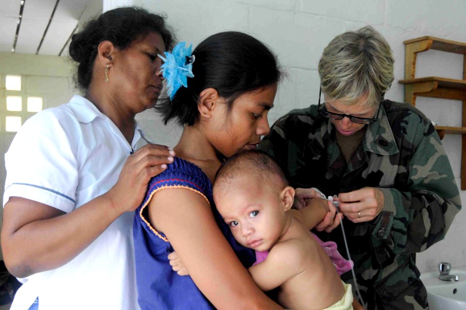 US Navy 090829-N-9689V-005 Navy pediatrician Capt. Tamara Grigsby treats an infant during a Pacific Partnership 2009 medical civic action project