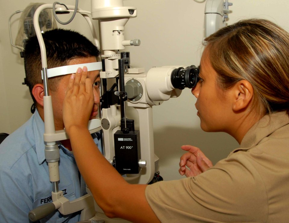 US Navy 090901-N-5617R-056 Navy optometrist Lt. Thuong Le, from Dallas, administers a slit lamp eye exam to Ship's Serviceman Seaman Alfernan Fernandez at Branch Medical Clinic Naval Base San Diego