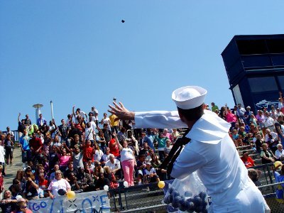 US Navy 090903-N-2888Q-022 Petty Officer 3rd Class Stephen Hamby, assigned to Navy Operation Support Center Columbus, throws Navy foam baseballs to students from Whetstone High School
