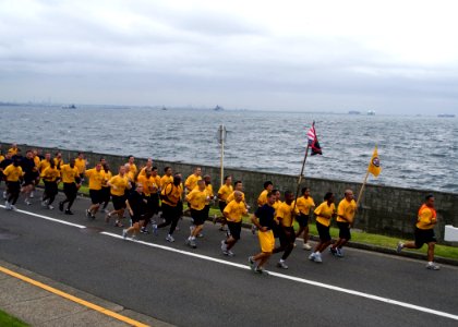 US Navy 090902-N-1251W-001 Chief petty officer (CPO) selects lead area commanders, flag officers and the Far East CPO Mess in a leadership run along the base seawall photo