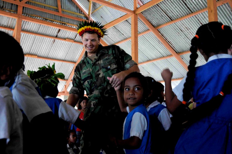 US Navy 090828-N-9689V-003 Lt. Darrin Davis dances with students during a Pacific Partnership 2009 community service project at Bikenbeu West Primary School.jpg 