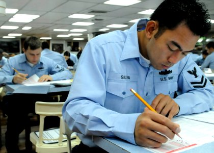 US Navy 090903-N-7478G-023 perations Specialist 2nd Class Virgilio Silva, assigned to the amphibious command ship USS Blue Ridge (LCC 19), takes the E-6 advancement exam