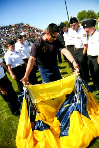 US Navy 090902-N-3271W-118 Aircrew Survival Equipmentman 1st Class Victor Maldonado, assigned to the U.S. Navy parachute team, the Leap Frogs, shows Navy Junior ROTC students how to pack his parachute after jumping into Frankli photo