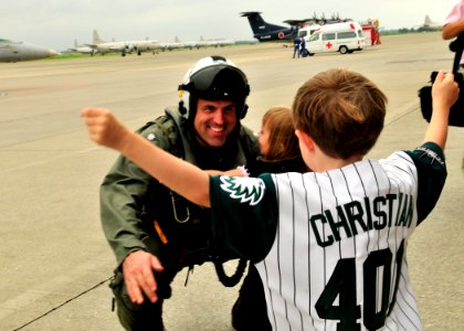 US Navy 090902-N-4031K-003 Cmdr. Gerald Hansen, commanding officer of the Dambusters of Strike Fighter Squadron (VFA) 195, greets his daughter and son during a homecoming celebration for Carrier Air Wing (CVW) 5