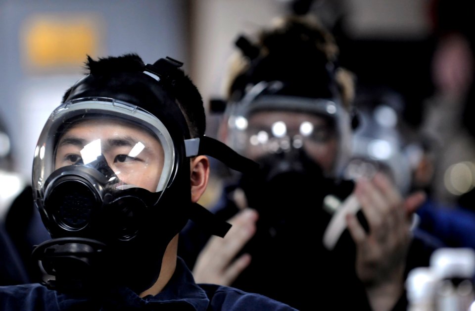 US Navy 090831-N-7280V-166 Sailors aboard the amphibious command ship USS Blue Ridge (LCC 19) don their gas masks during a chemical, biological, and radiological drill