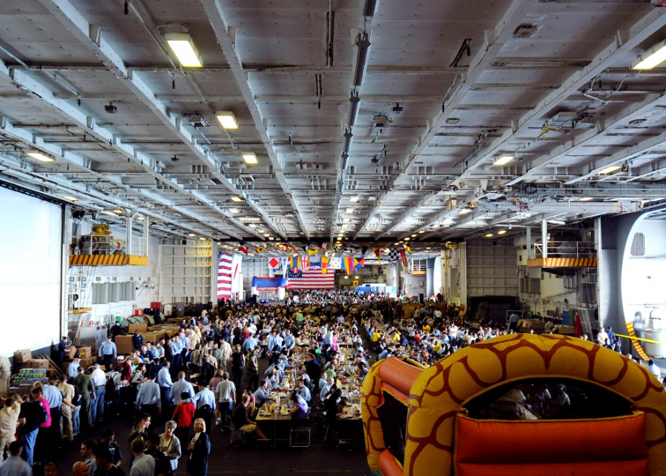 US Navy 090905-N-1062H-184 Family and guests of Sailors stationed aboard the aircraft carrier USS George Washington (CVN 73) enjoy food, live music, games and an inflatable bounce house in the ship's hangar bay