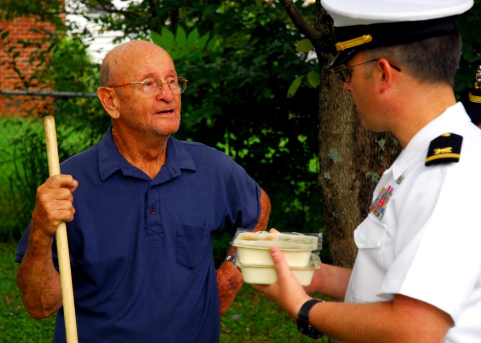 US Navy 090903-N-2903M-024 Ensign Jeff Griffith, assigned to the Nashville Navy Recruiting District, delivers food to Charles Russell of Knoxville as part of the Meals on Wheels program