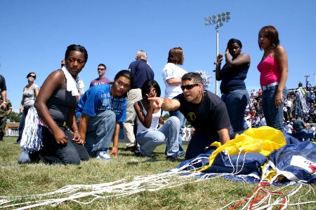 US Navy 090903-N-5366K-057 Special Warfare Operator 1st Class Robert Darakjy points to the opposite end of his parachute system while showing students how to pack his parachute at Whetstone High School during Central Ohio Navy