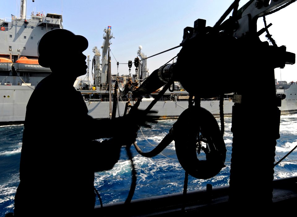 US Navy 090909-N-5345W-091 A Sailor recovers the messenger line at the port side fueling station aboard the amphibious dock landing ship USS Fort McHenry (LSD 43)