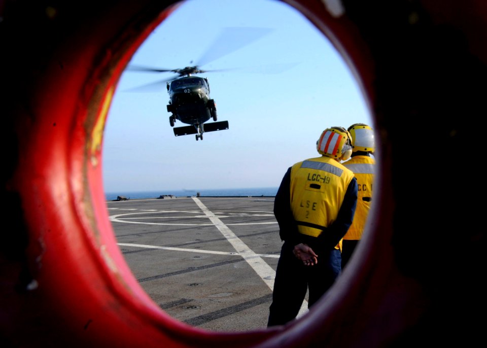 US Navy 090908-N-4399G-189 The amphibious command ship USS Blue Ridge (LCC 19) flight deck crew prepare to land an SH-60B Sea Hawk