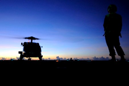 US Navy 090910-N-4399G-068 Boatswain's Mate 3rd Class Christine Bagley watches as an SH-60F Sea Hawk helicopter lands