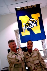 US Navy 090906-N-9818V-346 Master Chief Petty Officer of the Navy (MCPON) Rick West shows his Navy spirit with a Sailor during his tour of Expeditionary Medical Facility Kuwait
