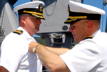 US Navy 090910-N-6692A-109 Capt. Mark Weber attaches a Command-at-sea pin to Cmdr. James Lowell after a change of command ceremony