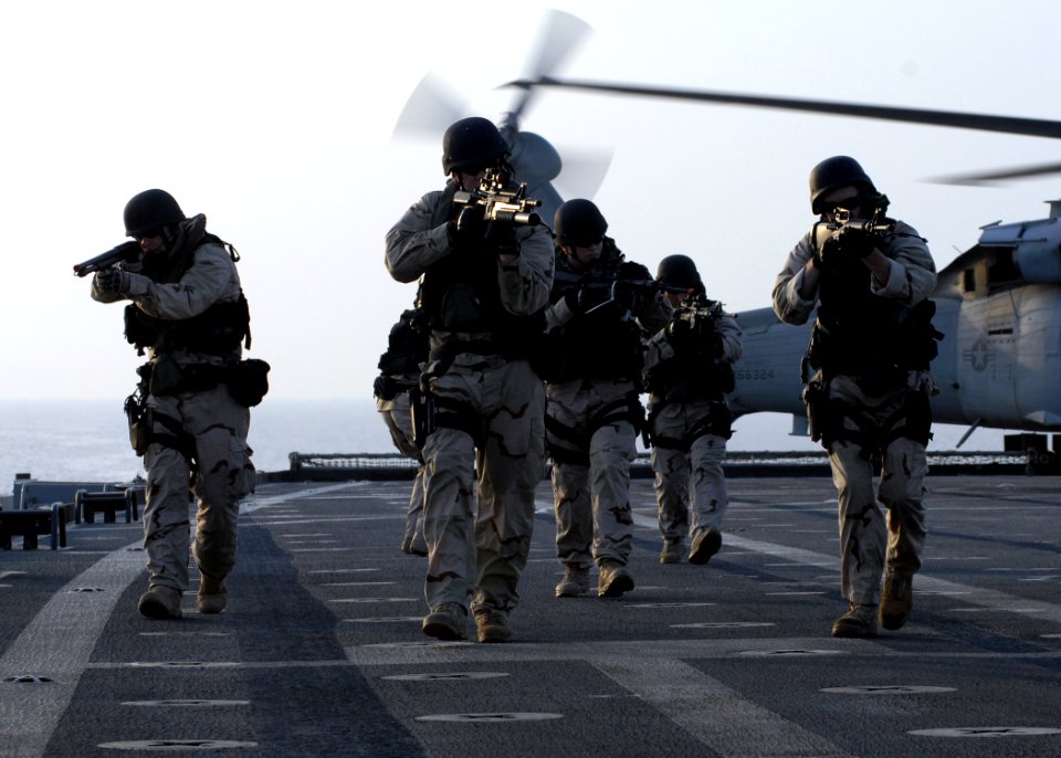 US Navy 090907-N-7088A-038 The visit, board, search and seizure team members, assigned to the amphibious transport dock ship USS Ponce (LPD 15), exit a helicopter