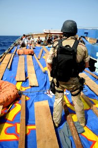 US Navy 090908-N-6814F-144 The visit, board, search, and seizure team member guard the crew aboard a dhow during a boarding operation near the guided-missile cruiser USS Anzio (CG 68)
