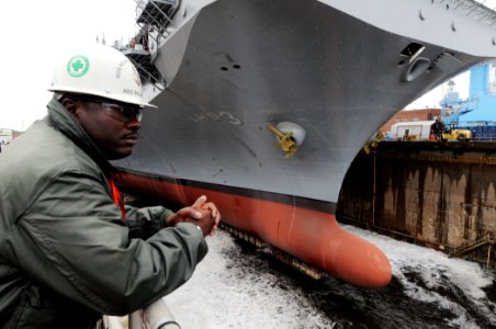 US Navy 090908-N-9774H-037 Chief Aviation Machinist's Mate Rodney Balance, leading chief petty officer of the amphibious assault ship USS Kearsarge (LHD 3) safety department, observes a dry dock flooding operation at Norfolk Na