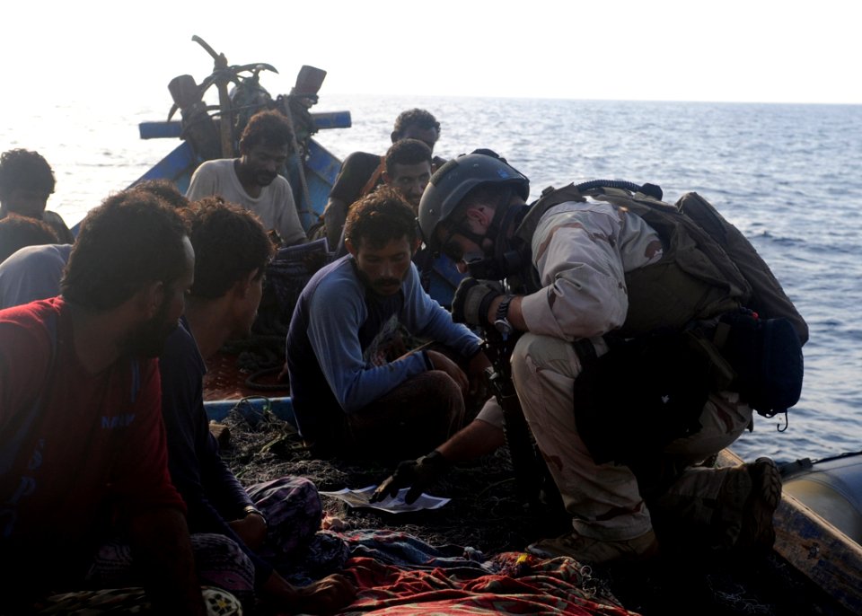 US Navy 090910-N-6814F-181 U.S. Coast Guard Machinery Technician 1st Class Dan Morales, assigned to Maritime Safety and Security Team 91104, asks Yemeni fishermen navigational questions
