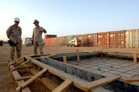 US Navy 090910-N-9818V-573 Builder 1st Class Jason Shurtz shows Master Chief Petty Officer of the Navy (MCPON) Rick West the work sites of Naval Mobile Construction Battalion (NMCB) 74 during a tour of the base in Kandahar