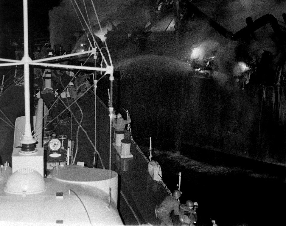 USS Belknap spraying from USS Claude V. Ricketts 19751122