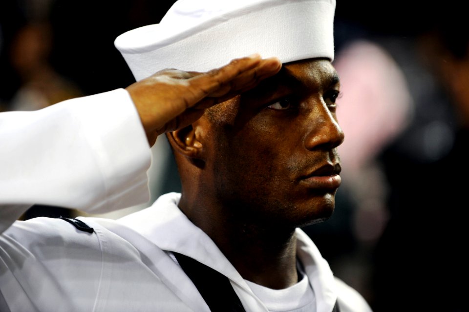 US Navy 090911-N-0413R-227 Chief Information Systems Technician Hakim Bristow salutes during the national anthem during a pre-game ceremony at Yankee Stadium