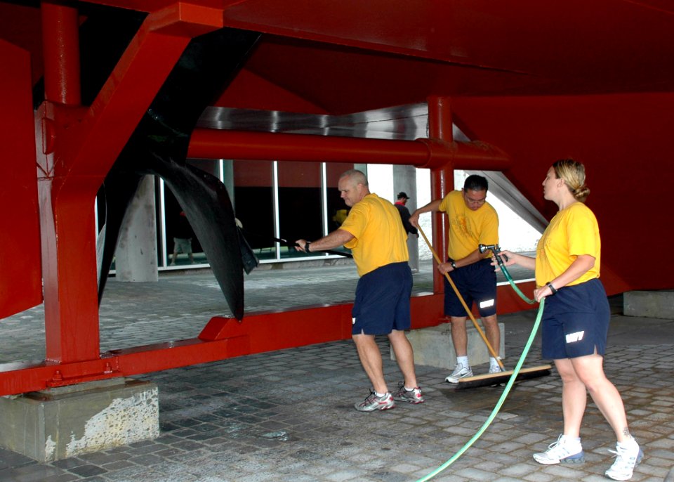 US Navy 090910-N-5292M-606 Personel Specialist 1st class, chief select, Andy Hick scrubs the propeller of the ironclad replica of the USS Monitor at the Mariners' Museum in Newport News, Va